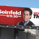 The billboard appears to suggest that comedian Jerry Seinfeld is the star of the show, and that the program may focus on his life in some way.